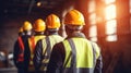Group of workers in hardhats and reflective safety vests are seen from the back, standing together. AI generated Royalty Free Stock Photo