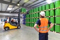 Group of workers in the logistics industry work in a warehouse w