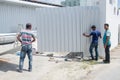 Group workers repairing gates