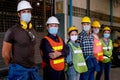 Group of workers or technician with mask stand and look right side direction and stay in factory area Royalty Free Stock Photo