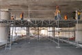 Group of workers working on a scaffolding in a parking lot.