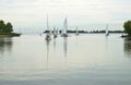 Group yachts exit harbor calm water. Royalty Free Stock Photo