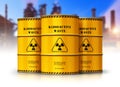 Group of yellow drums with radioactive waste in front of nuclear