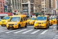 Group of yellow taxi cabs rush business man and tourists around Manhattan