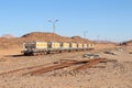 Group of yellow wagons with material for nitrogen fertilizers in desert