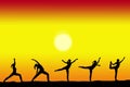 Group of yoga female silhouettes with a sunset on the background and copy space for your text Royalty Free Stock Photo