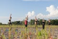 group yoga performing sun salutations outdoors Royalty Free Stock Photo