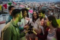 Group of young adult friends having fun toasting and drinking alcoholic glasses. Multiracial people clinking bottles of Royalty Free Stock Photo