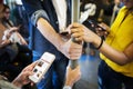 Group of young adult friends using smartphones in the subway Royalty Free Stock Photo