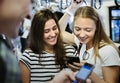 Group of young adult friends using smartphones in the subway Royalty Free Stock Photo