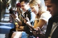 Group of young adult friends using smartphones in the subway Royalty Free Stock Photo