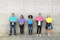 Group of young adults outdoors holding empty placard copyspace t Royalty Free Stock Photo