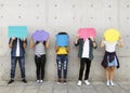 Group of young adults outdoors holding empty placard