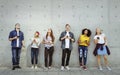 Group of young adults outdoors using smartphones looking up