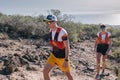 Group of young adults training and running together through trails on the hillside outdoors in nature Royalty Free Stock Photo