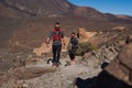 Group of young adults training and running together through trails on the hillside outdoors in nature Royalty Free Stock Photo