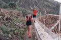 Group of young adults training and running together through trails on the hillside outdoors in nature Royalty Free Stock Photo