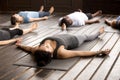 Group of sporty people in Savasana pose Royalty Free Stock Photo