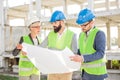 Group of young architects or business partners meeting on a construction site Royalty Free Stock Photo