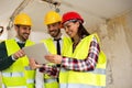 Group of young arhitects with l tablet on construction site Royalty Free Stock Photo