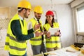 Group of young arhitects withl tablet on construction site Royalty Free Stock Photo