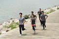 Group of young asian adults running outdoors Royalty Free Stock Photo