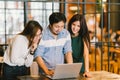 Group of young Asian business colleagues in team casual discussion, startup business meeting or teamwork brainstorm concept Royalty Free Stock Photo