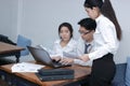 Group of young Asian business people working together with laptop computer at workplace of office. Teamwork brainstroming concept. Royalty Free Stock Photo