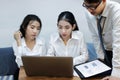 Group of young Asian business people working together in the office. Business teamwork cooperation partnership concept Royalty Free Stock Photo