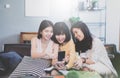 Group of young asian female friends in coffee shop,Using digital devices,chatting with smartphones Royalty Free Stock Photo