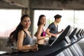 Asian friends run on machine at gym Royalty Free Stock Photo