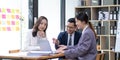 Group of young asian modern people in smart casual wear having a brainstorm meeting. Group of young asian business Royalty Free Stock Photo