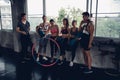 Group of young asian people in sportswear talking after a workout in gym Royalty Free Stock Photo