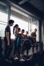 Group of young asian people in sportswear talking after a workout in gym Royalty Free Stock Photo