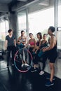 Group of young asian people in sportswear talking after a workout in gym Royalty Free Stock Photo