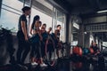 Group of young asian people in sportswear talking after a workout in gym Royalty Free Stock Photo