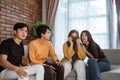 Group of young Asian sitting together on the couch looked disappointed