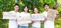 Group of young Asian volunteers holding signs supporting nature and the environment.