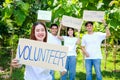 Group of young Asian volunteers holding signs supporting nature and the environment. Social volunteer concept.