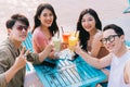 A group of young asians enjoy a trip to the sea on a summer vacation