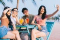 A group of young asians enjoy a trip to the sea on a summer vacation