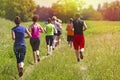 Group of young athlete running marathon outdoors