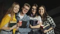 Group of Friend Standing Together Holding Books