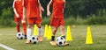 A group of young boys play balls on soccer drills. Football dribbling exercises