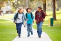 Group Of Young Boys Running Towards Camera In Park