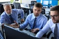 Group of young business men in formalwear working using computers while sitting in the office Royalty Free Stock Photo