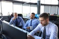 Group of young business men in formalwear working using computers while sitting in the office Royalty Free Stock Photo