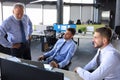 Group of young business men in formalwear working using computers while sitting in the office Royalty Free Stock Photo