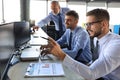 Group of young business men in formalwear working using computers while sitting in the office Royalty Free Stock Photo