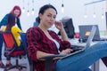 Group of a young business multiethnic people brainstorming and discussing business plan on meeting at sunny bright office interior Royalty Free Stock Photo